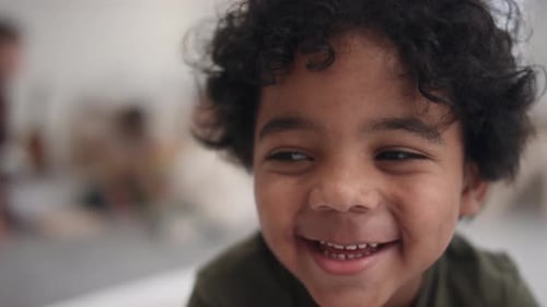 Happy Child Smiles at Camera Close Up