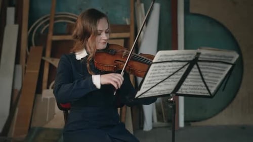 Woman Playing Violin in Art Studio