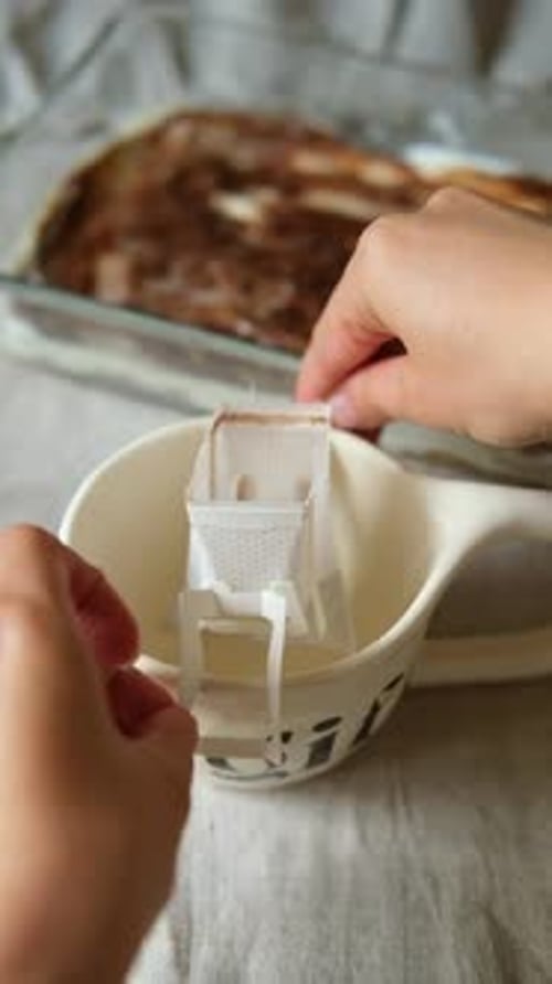 Hands Preparing Disposable Pour Over Coffee