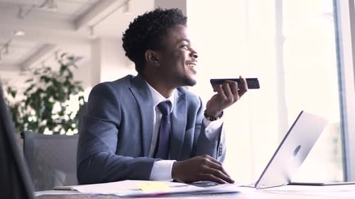Smiling Young Businessman Talking on Smart Phone in Office 2024 Years