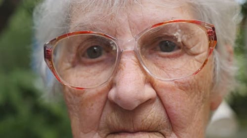 Senior Woman with Gray Hair and Glasses Close Up