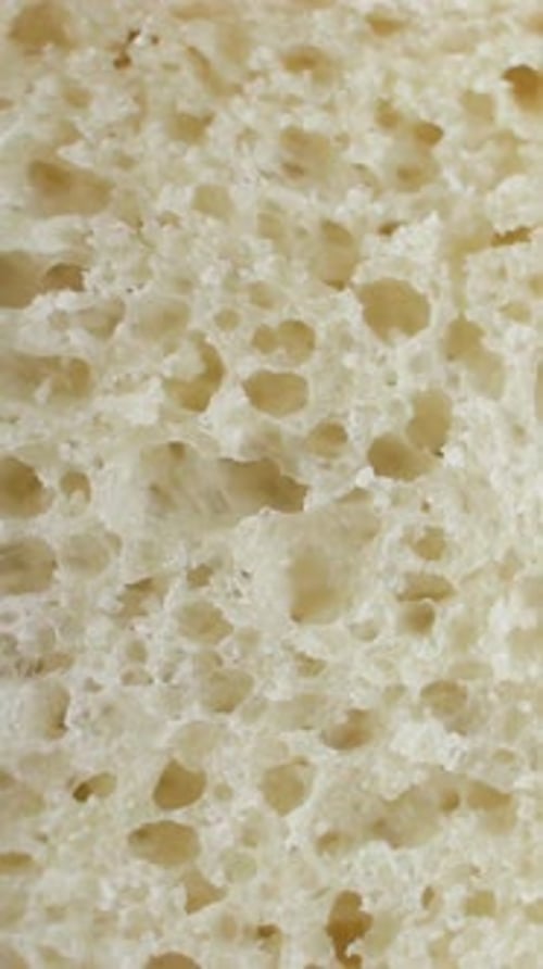Background of White Bread Rotating Extreme Close Up Macro Shot Vertical Video