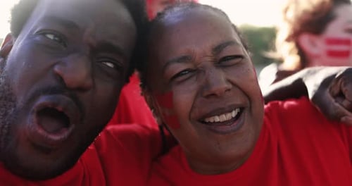 Enthusiastic fans cheering together at sporting event