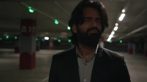 Desperate Stressed Arabian Man Walking in Underground Parking Frustrated Worried Depressed