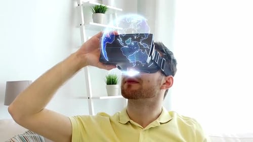 Man uses VR headset, watching digital globe