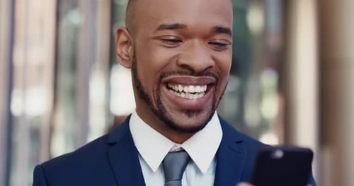 4k video footage of a young businessman using a cellphone in an office