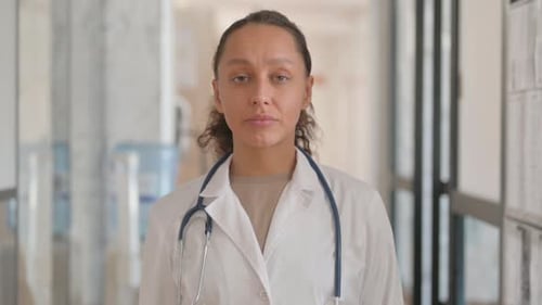 Adult Woman in Doctor's Coat in Hospital