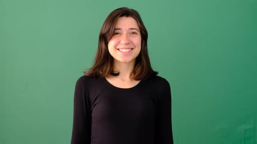 Smiling Young Woman Against Green Screen Background