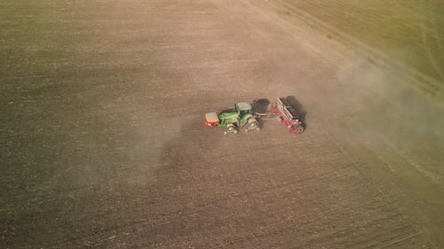 Tractor on the field seeding wheat