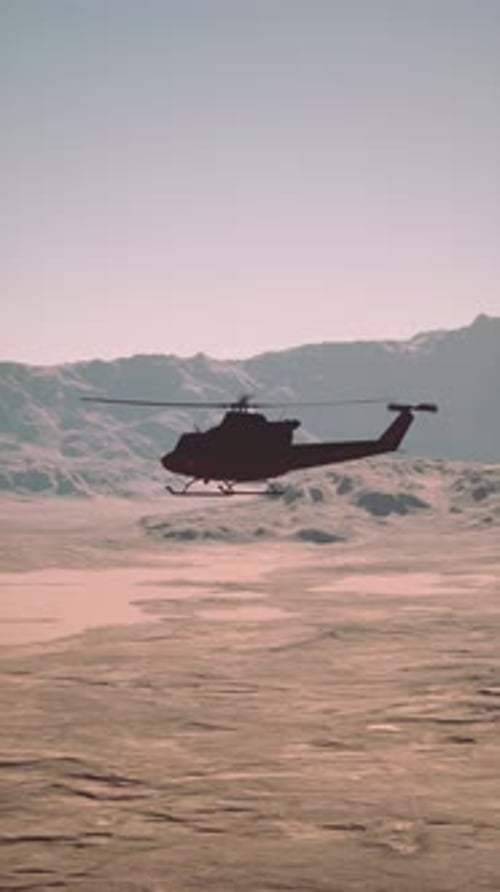 Helicopter Flying Over Desert Landscape