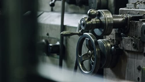 Precision metalworking lathe in action with spinning wheels