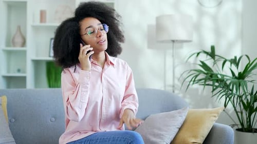 Woman Talking on Phone Indoors on Couch
