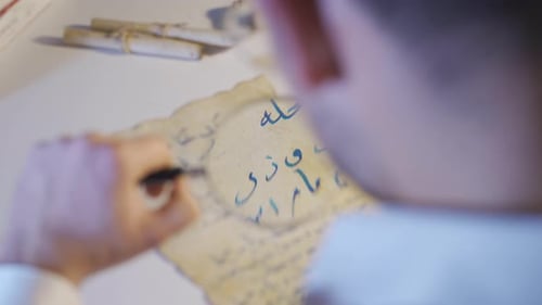 The inscription scientist examines the medieval correspondence letter.