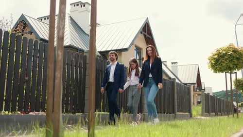 Caucasian Beautiful Mother Father and Their Cute Happy Daughter Walking From School After Lesson