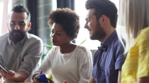 Smiling group of young adults at office meeting
