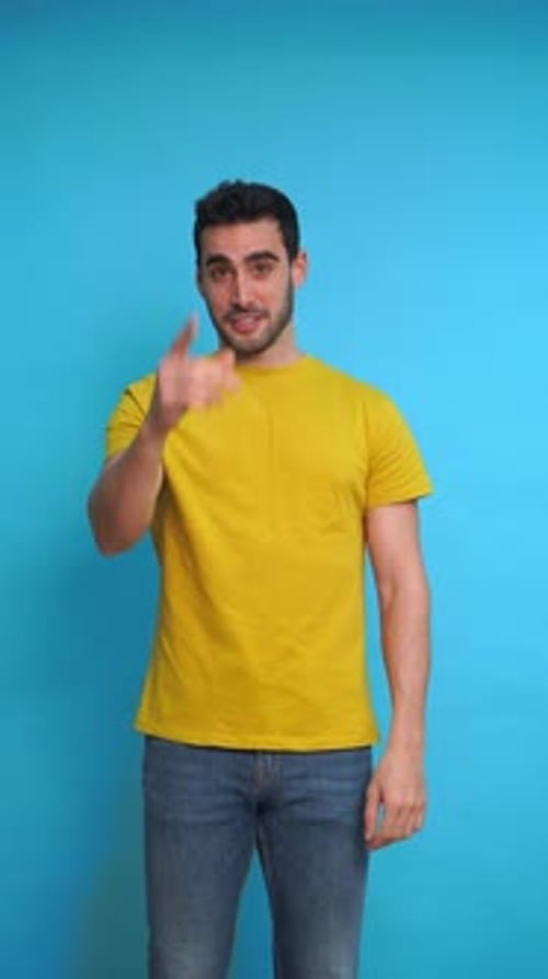 Cheerful Young Man Showing Thumbs Up