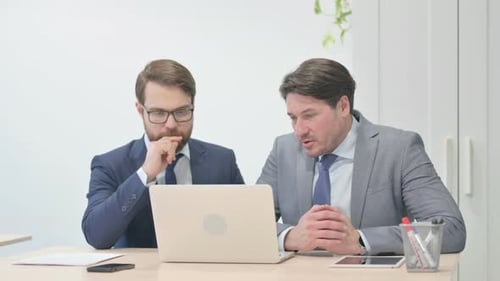 Businessmen Working on Laptop in Office
