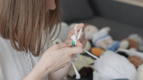 Woman Crocheting White Yarn at Home, Close Up