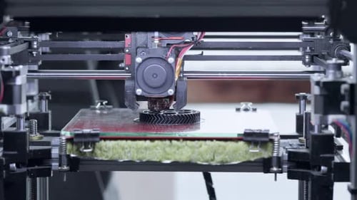 3D printer printing detail from plastic. Automatic three dimensional 3d printer performs plastic.