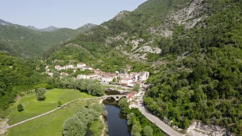 Aerial view of bridge and town in valley, Montenegro.