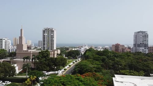 drone panning to the left of the city of santo domingo with view of the temple