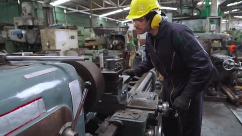 Smart factory worker using machine in factory workshop. Industry and engineering concept.
