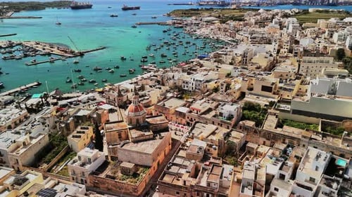 Stunning aerial view of Malta's coastal town and vibrant harbor