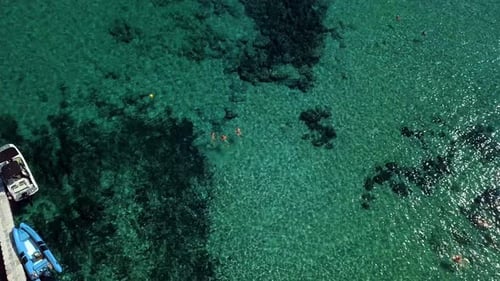 drone shooting with clear turquoise water of the Mediterranean Sea, people bathe