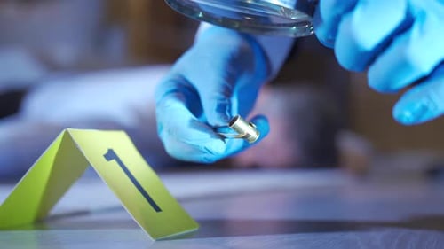 Crime Scene Bullet Examination With Magnifying Glass