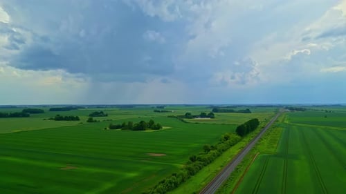 Rain clouds flowing above rural landscape, aerial view