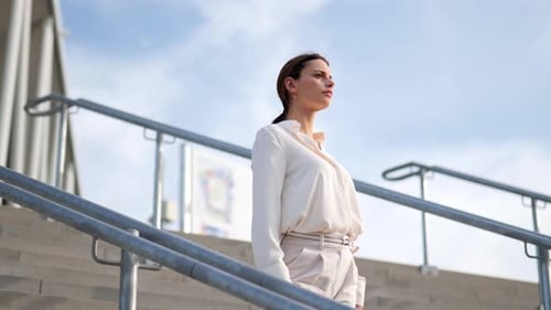 Woman Walks Down Modern Urban Outdoor Staircase