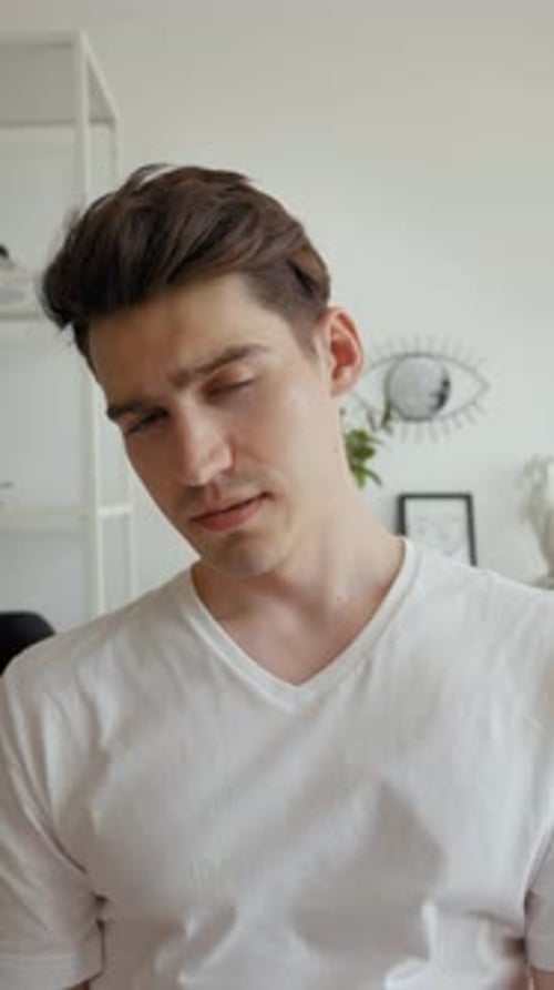 Man Touching Face Indoors