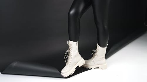 Cream Boots on Person With Black Leggings