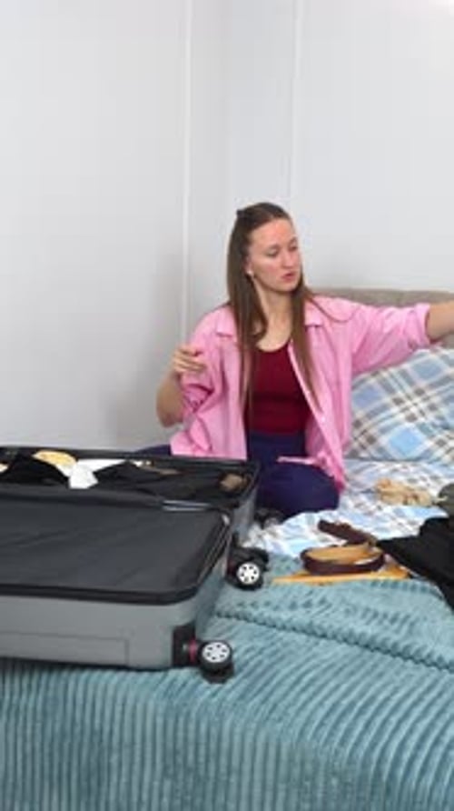 Woman Packing Suitcase in Bedroom