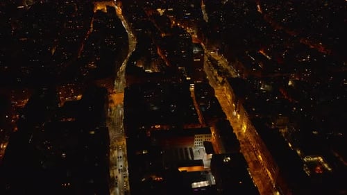 Fly Above Block of Buildings Between Two Illuminated Streets Aerial View of Urban District at Night