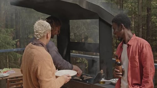 Friends Having Grilled Meat and Hanging Out at Outdoor Party in Woods