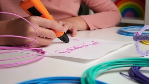 Child Creates 3D Art with Pen on Desk