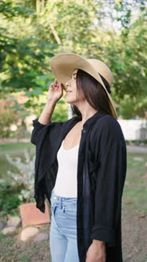 Mexican woman enjoying a sunny day walking in a park