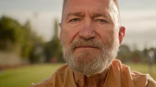 Close Up Old Caucasian Man Pensioner Looking at Camera Serious Face Expression Calm Silently