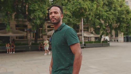 Young man tourist walks along the square of the old city, considers the sights