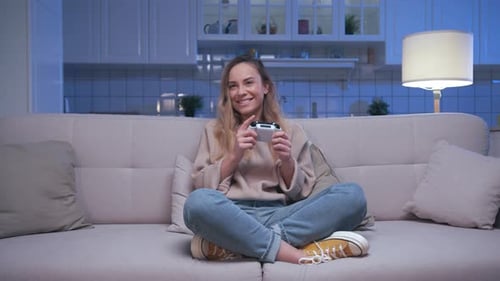Woman Plays Video Game at Home at Night