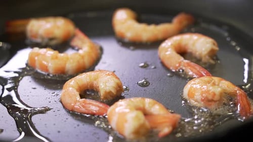 Chef is Frying Shrimps on a Pan
