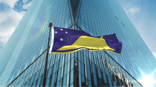 Waving Tokelau Flag in Front of Corporate Skyscraper
