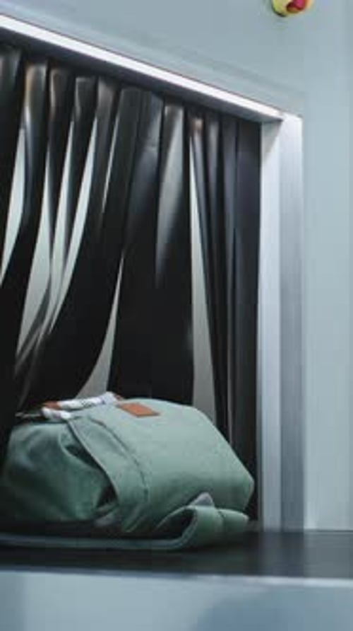 Airport Security Checkpoint TSA Worker Puts Baggage and Personal Items in Xray Metal Detector