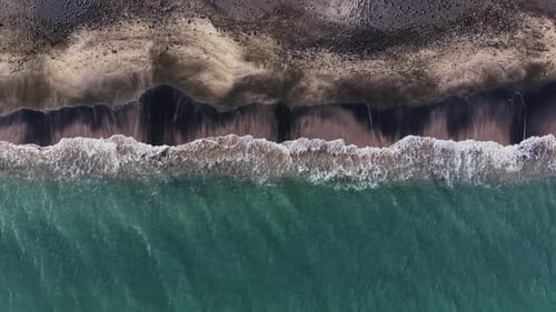 Waves gently touch the shore on a sunny day at the beach