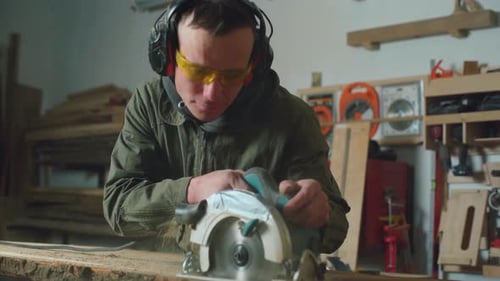 Man Using Circular Saw in Workshop