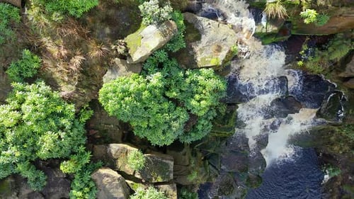 Aerial drone footage of a tall rocky waterfall in the Yorkshire Dales, Pennies. Moorland scene of a