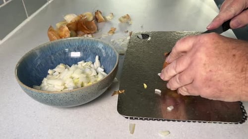 Man Dicing an Onion in Home Kitchen