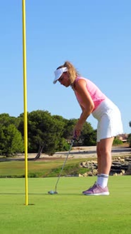 Golfer putting on green, sequence of precise movements