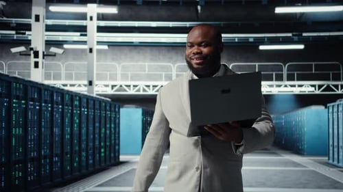 Server Room Worker Auditing Systems for Vulnerabilities Using Software on Laptop